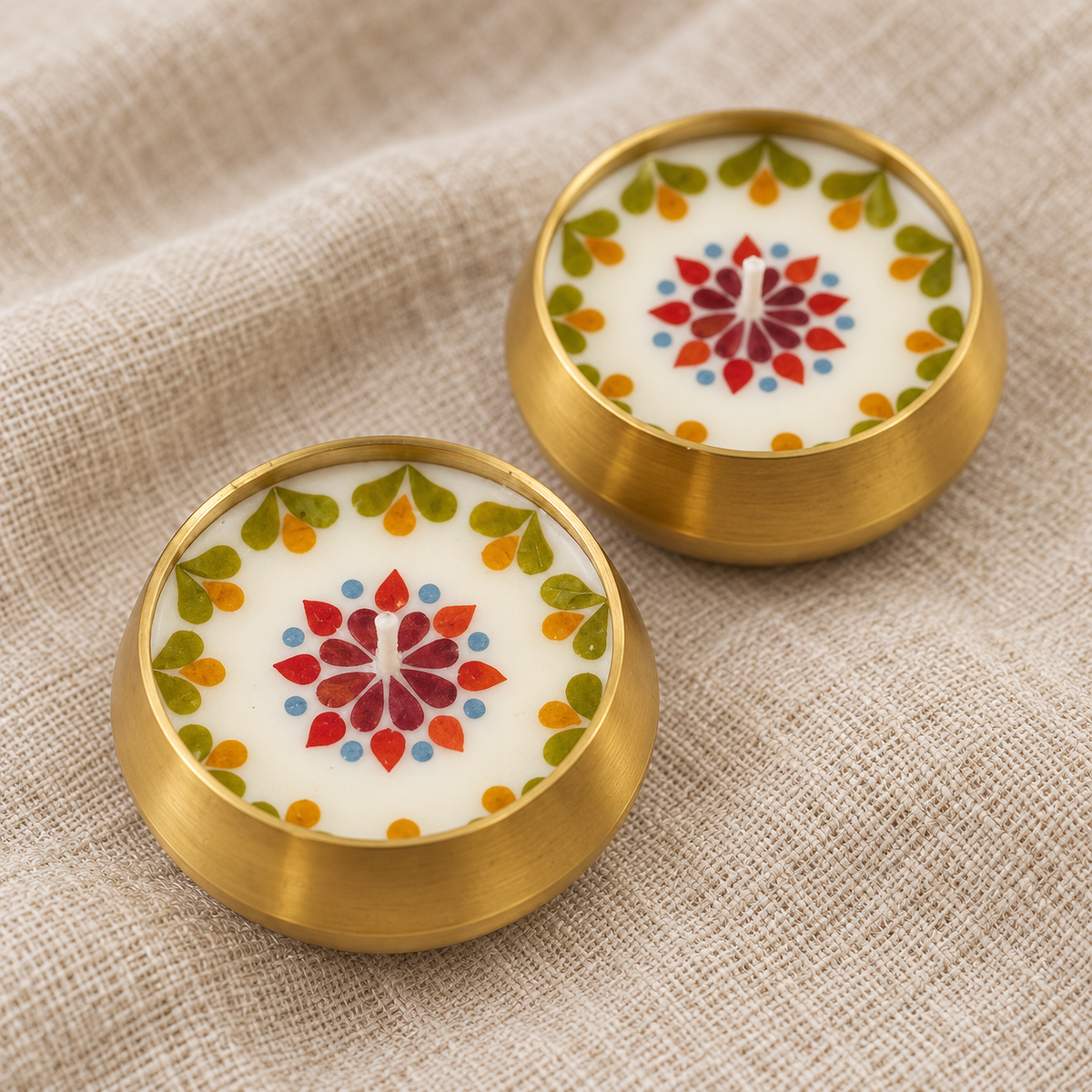 Pressed-Flower Brass Urli Candles, Set of 2, close-up of the wax top