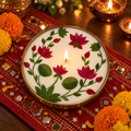Lotus Soy Wax Candle in a Brass Urli, 6 in, lit for Diwali on a mirror-work runner