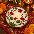 Lotus Soy Wax Candle in a Brass Urli, 6 in, lit for Diwali on a mirror-work runner