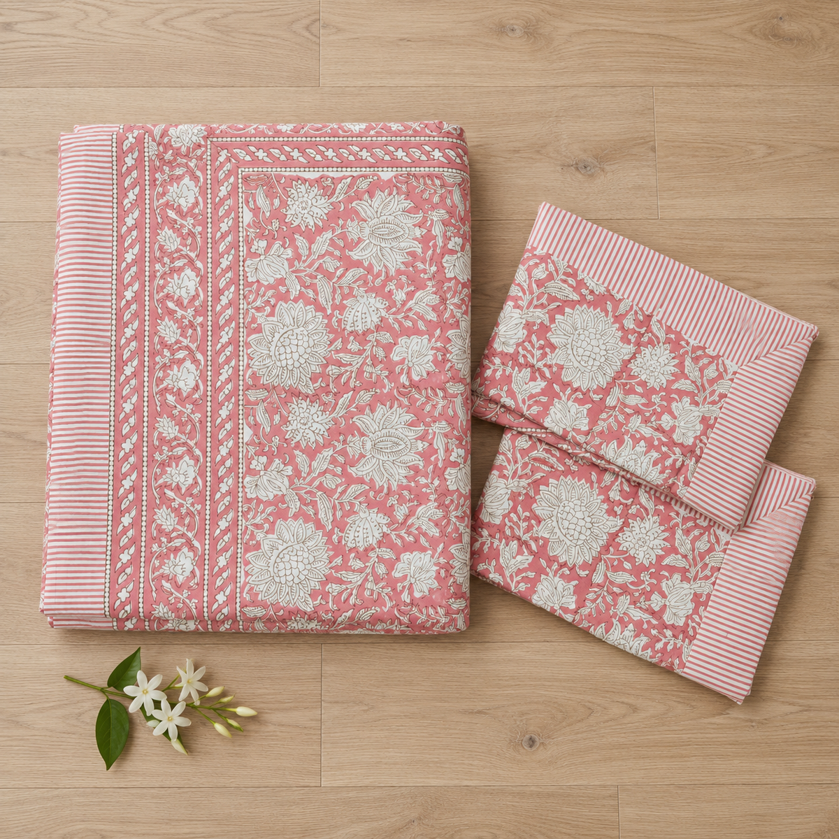 Pink Floral Jaal Bedsheet Set, folded with its pillow covers