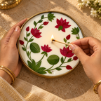 Lotus Soy Wax Candle in a Brass Urli, 6 in, being lit by hand