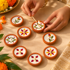 Dried-Flower Soy Wax Terracotta Diyas, Set of 16, being lit by hand