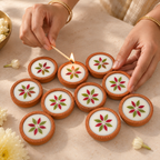 Mini Pressed-Flower Terracotta Diyas, 10 in 5 Gift Boxes, being lit by hand