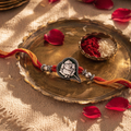 Hand-Finished Paan-Leaf Ganesha — Enamel Brass Rakhi