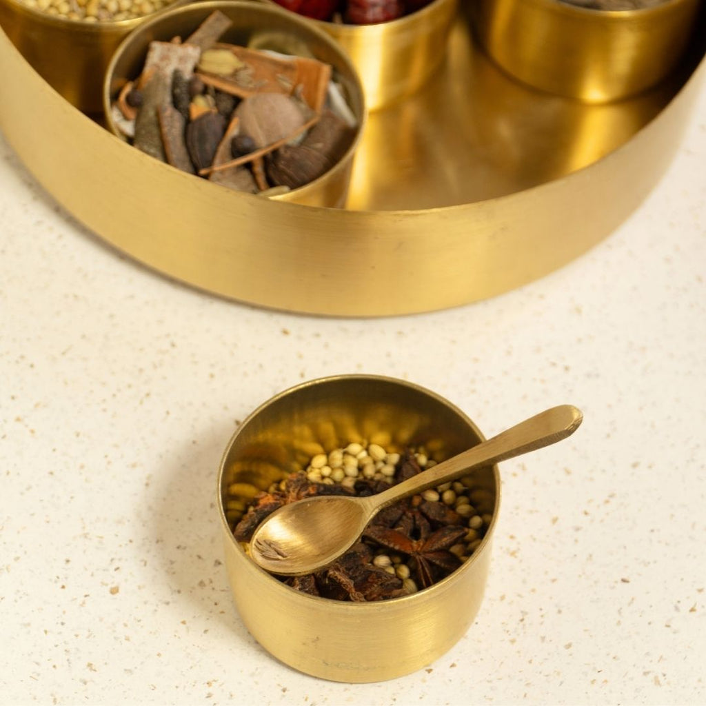 Kitchen masala box or spice box made with Pure Brass in an Antique Kanjeevaram Design. The masala box comes with 7 detachable containers and spoon