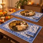 Blue Vine Floral Placemat and Napkin Set of 12, set for a Diwali meal with brass thalis and diyas