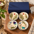 Lavender and Lemongrass Tin Candle Gift Box, Set of 4, on a teak console in daylight
