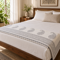 Grey Paisley Dohar, folded at the foot of a made bed