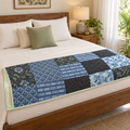 Blue Patchwork Dohar, folded at the foot of a made bed