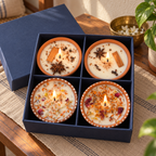 Floral and Spice Terracotta Candle Gift Box, Set of 4, on a teak console in daylight