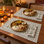 Olive Floral Placemat and Napkin Set of 12, set for a Diwali meal with brass thalis and diyas