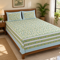 Yellow Green Floral Bedsheet Set, on a made double bed in a bright bedroom
