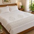 Beige Tree Motif Dohar, folded at the foot of a made bed