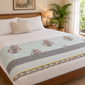 Aqua Floral Dohar, folded at the foot of a made bed
