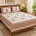 Rust Floral Buta Bedsheet Set, on a made double bed in a bright bedroom