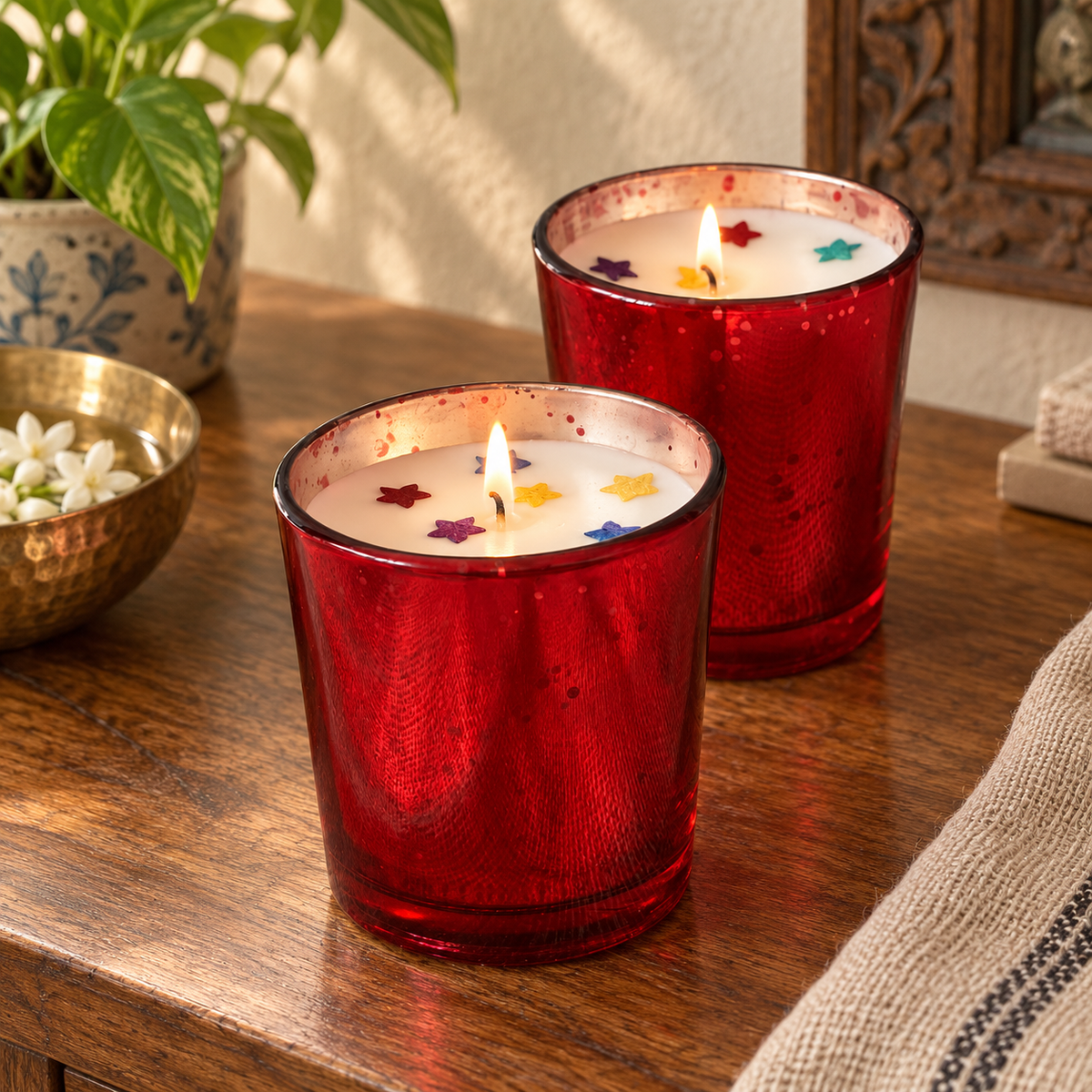 Red Glass Rose-Scented Soy Wax Candles, Set of 2, on a teak console in daylight