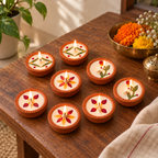 Dried-Flower Soy Wax Terracotta Diyas, Set of 16, in a home in daylight